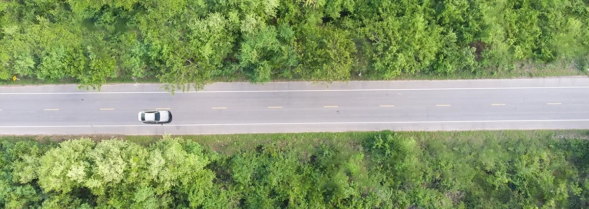 vue-aerienne-de-la-route-qui-passe-dans-la-foret-avec-une-voiture-qui-passe (1)